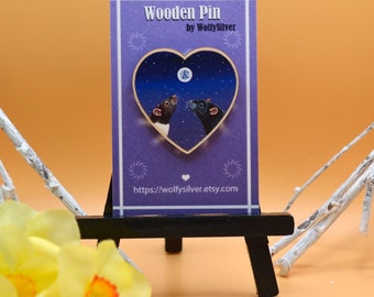May include: Wooden pin featuring two rats looking at each other under a starry night sky in a heart-shaped frame. The pin is made by WollySilver and has a website address on the back.