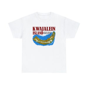May include: White t-shirt featuring a map of Kwajalein Island with the text "KWAJALEIN ISLAND" in maroon and "PACIFIC MISSILE RANGE FACILITY" in white. The map is outlined in blue and green.