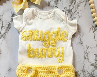 Easter onesie with hand embroidered words Sunggle Bunny, Crocheted bunny tail diaper cover, Easter bow / first Easter outfit