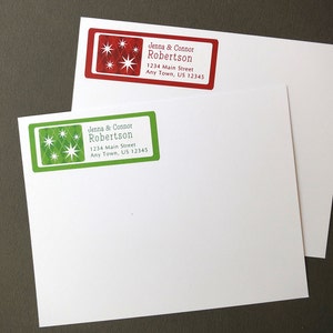 May include: Two red and green address labels with a starburst design. The labels read "Jenna & Connor Robertson 1234 Main Street Any Town, US 12345".