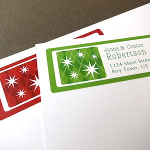 May include: A green and red holiday address label with a diamond pattern and white stars. The label reads "Jenna & Connor Robertson, 1234 Main Street, Any Town, US 12345".