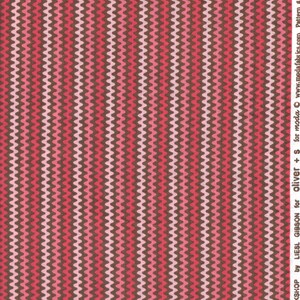 May include: A textile featuring a repeating wavy pattern in shades of pink, red, and brown. The design has vertical stripes of alternating colours, creating a textured appearance. The text "MODERN WORKSHOP by LIESL GIBSON for oliver + s for moda" is visible.