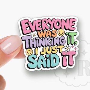 May include: A colorful acrylic badge reel topper with the text "Everyone was thinking it, I just said it". The topper is designed with a rainbow color scheme and features a smiley face and flowers.
