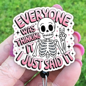 May include: A pink and white badge holder with a skeleton holding a peace sign and the text "Everyone was thinking it I just said it".