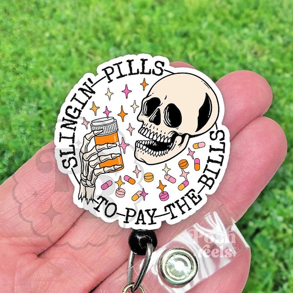 May include: A white badge with the text "SLINGIN' PILLS TO PAY THE BILLS" encircling a skull and a skeleton hand holding a pill bottle. The design includes stars and pills in pink, orange, and yellow.