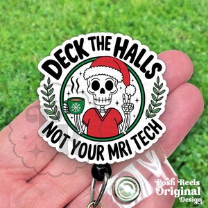 May include: A white badge reel with a cartoon skeleton wearing a Santa hat and red scrubs, holding a coffee cup with a snowflake design. The text reads "Deck the Halls Not Your MRI Tech."