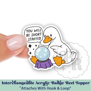 May include: A white ceramic mug with a black handle and the text "But First, Coffee" in a black, bold font. The mug is sitting on a wooden surface. The mug is approximately 4 inches tall.