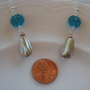 Shell earrings with a translucent glass flower bead