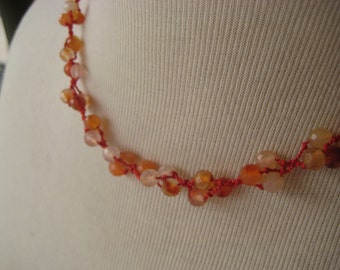 Necklace with carnelian beads on red silk cord