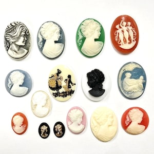 May include: A collection of fourteen oval-shaped cameos featuring various relief carvings of human profiles, figures, and scenes in diverse colors including black, white, blue, green, orange, and pink, arranged in a grid on a plain white background.
