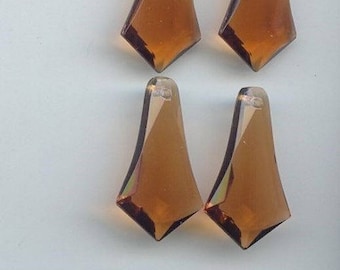 May include: Four amber-colored glass teardrop-shaped crystal pendants with a faceted design.