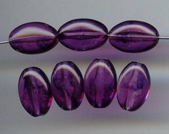 May include: A set of eight purple glass beads with a white iridescent sheen. The beads are oval shaped and have a smooth, polished finish.