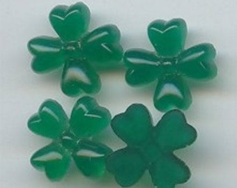 May include: Four green four-leaf clover shaped resin cabochons.