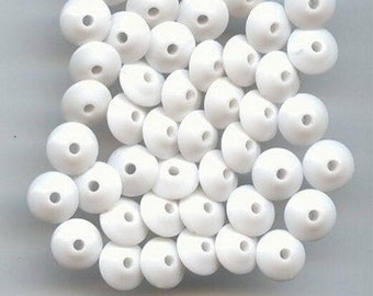 May include: A large pile of white plastic beads. The beads are round with a flat top and a small hole in the center.
