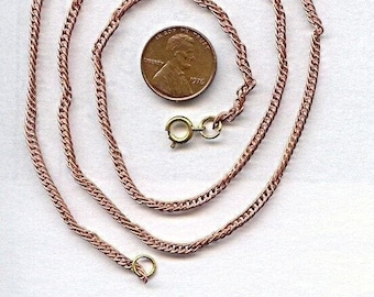 May include: A rose gold chain necklace with a lobster clasp. The chain is about 18 inches long and is shown next to a US penny for scale.
