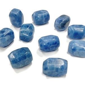 May include: Ten blue gemstone beads with a cloudy, marbled pattern. The beads are faceted and have a slightly irregular shape.
