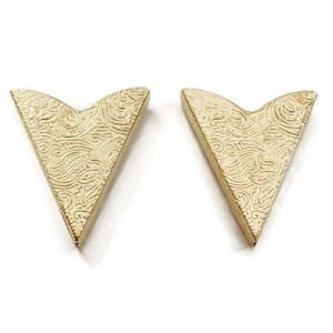 Puede incluir: Dos protectores de esquina de metal de color dorado con un patrón de espiral decorativo.