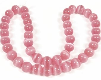 38 Cat's Eye Fiber Optic Glass Muted Pink 10mm. Smooth Round Beads 2604