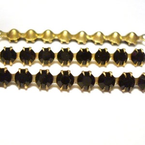 May include: Three gold chains with black rhinestones. The chains are different lengths and have a loop at each end.