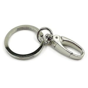 May include: Silver key chain with a round ring and a swivel clasp.