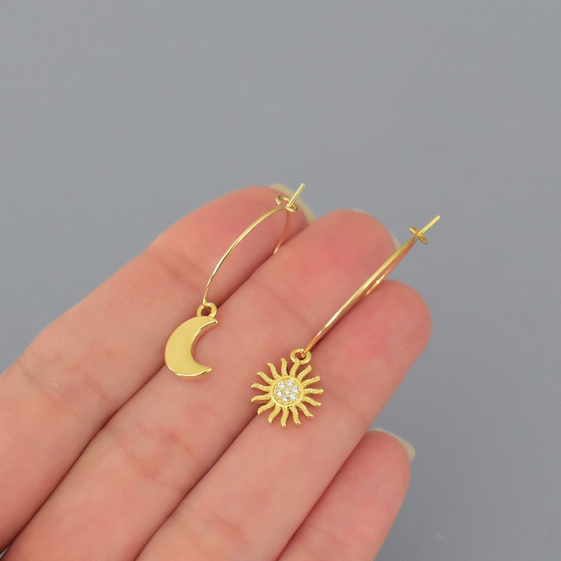 18K gold filled brass moon and sun charms on 18K gold 316 surgical stainless steel round hoop earrings . Minimalist super thin hoop ear wires by WrappedinYou