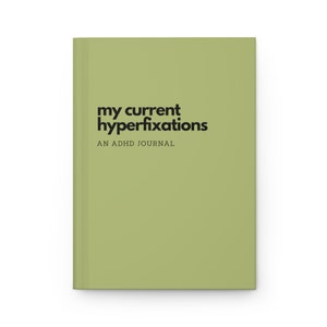 May include: A green journal with the text "my current hyperfixations" and "AN ADHD JOURNAL" in black.