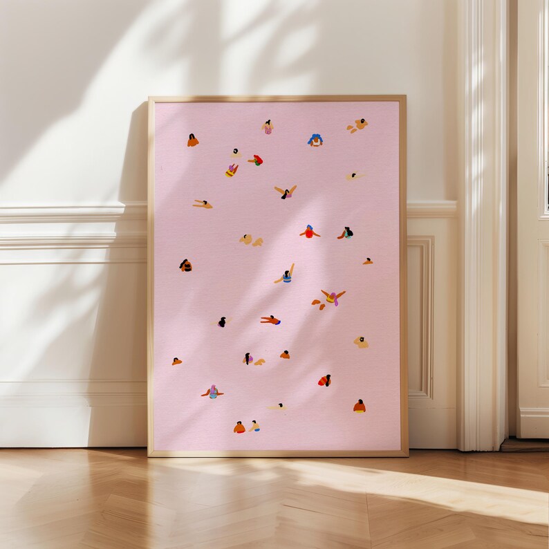 May include: A framed print with a pink background and a pattern of small, colorful figures in various poses. The figures appear to be swimming or floating in the water.