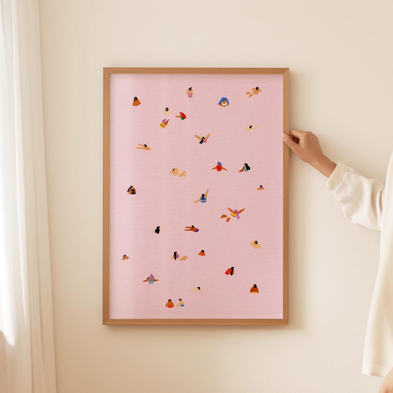 May include: A framed print with a pink background and a pattern of people swimming in a pool. The people are all different colors and sizes, and they are swimming in various positions.