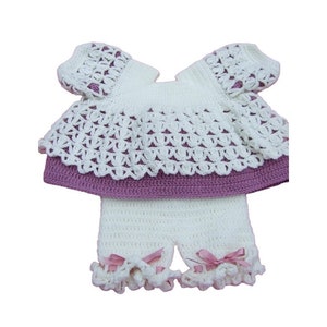 Hand crocheted baby angel top and shorts in mauve and cream on a white background