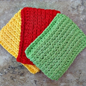 May include: Three crocheted dishcloths in yellow, red, and green. The dishcloths are stacked on top of each other.