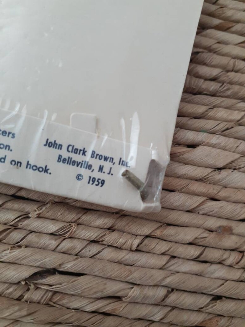 May include: Close-up of a white label with the text "John Clark Brown, Inc. Belleville, N.J. &copy; 1959" printed on it.