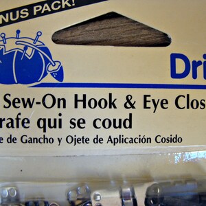 May include: A package of 12 sew-on hook and eye closures. The package is labeled "Dritz" and includes the text "12 Sew-On Hook & Eye Closures, Agrafe qui se coud, Cierre de Gancho y Ojete de Aplicaci&oacute;n Cosido".