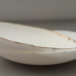 Small shallow dishes from stoneware fine bone china in pure white with shimmering gold finish, stoneware porcelain, white ceramic,