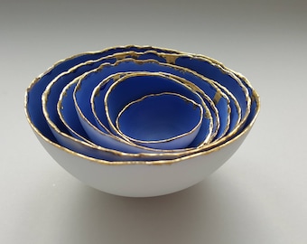Set of 7 stoneware fine bone china nesting bowls in blue and white with real gold finish.