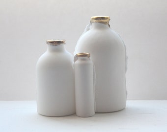 Trio of English fine bone china bottles with gold rims