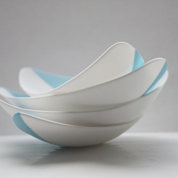 Stoneware fine bone china bowl with a touch of blue resembles a small boat.