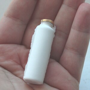 Small white bottle with gold finish from bone china. image 4