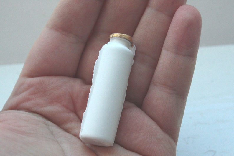 Small white bottle with gold finish from bone china. image 4