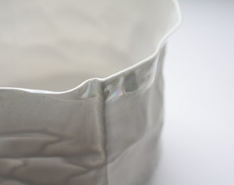 Crumpled paper looking vessel made out of English fine bone china and mother of pearl.