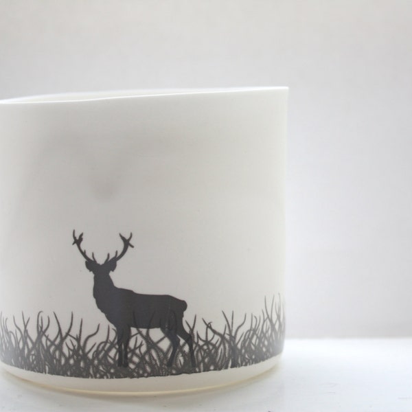 Porcelain candle holder. English fine white bone china vase or tea light holder in stoneware with a black silhouette of a stag.
