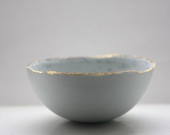 Stoneware Parian porcelain bowl in duck egg blue with mat gold rims mat interior and crystals.