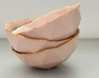 Geometric faceted polyhedron in tan pink bowl made from fine bone china with real mat gold finish - ring dish