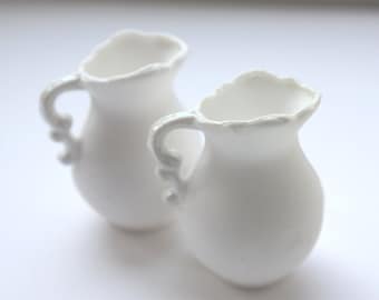 Mini jug made from pure white fine bone china and mother of pearl rim and handle in stoneware