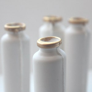 Small white bottle with gold finish from bone china. image 1