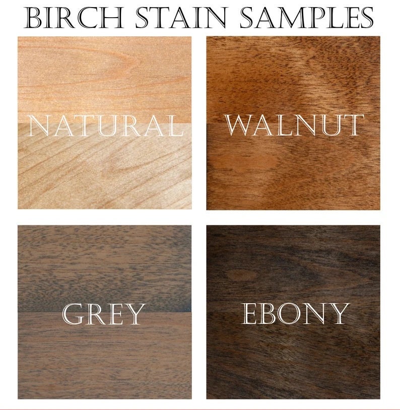 May include: Four wood stain samples on birch wood. The samples are labelled "Natural", "Walnut", "Grey", and "Ebony".