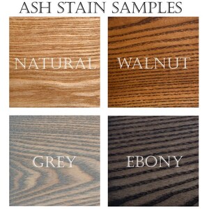 May include: Four wood samples stained in different colours: natural, walnut, grey, and ebony. The samples are arranged in a grid.