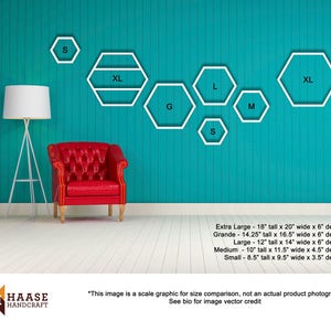 May include: A size chart for hexagonal wall shelves in various sizes, including extra large, grande, large, medium, and small. The chart shows the dimensions of each size in inches, including height, width, and depth. The chart is displayed on a teal wall with a red armchair in the foreground.