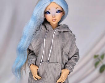 May include: A gray hooded sweatshirt with a ribbed texture and a white drawstring. The hoodie has a large pocket on the front.
