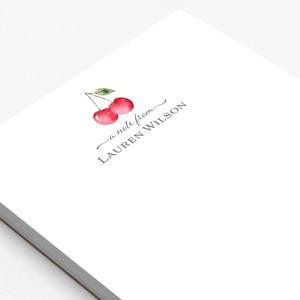 May include: A white notepad with a cherry illustration and the text "a note from LAUREN WILSON".