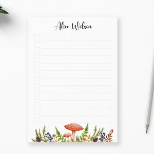May include: A white notepad with a checklist and the name "Alice Wilson" at the top. The bottom of the notepad features a border of red and white mushrooms, green ferns, and blue berries.